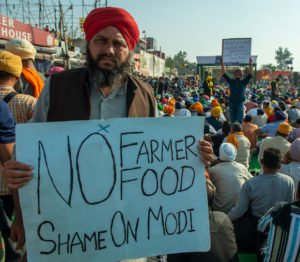 India's farmers end year long protest