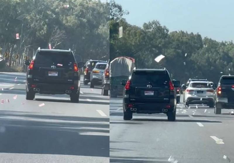 Watch: Currency notes rain down on motorway amid economic crisis