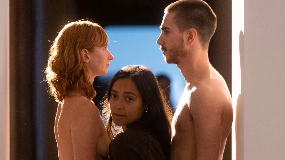 Visitors must squeeza between naked models to enter this art exhibition